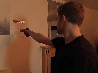 Aiming an unloaded pistol at a...