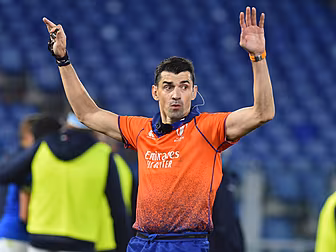 Referee Gauzere holds hands up...