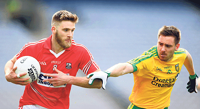 In control: Corks Eoin Cadogan holds off the challenge of Martin Reilly, Donegal, during Sundays Allianz Football League semi-final in Croke Park.