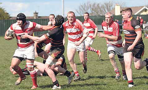 Skibbereen flanker Richie Byrne holds off the attention of an Old Christians defender during their Cork County Cup semi-final in Rathcooney on Sunday. 