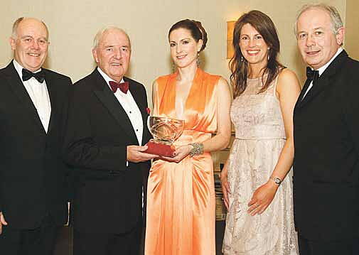 Happier times: Bill OHerlihy presenting the Celtic Ross West Cork Sports Star of the Year 2012 award to Ruth Anne Sheahan of Leap at the gala banquet in Rosscarbery, where he proved a popular special guest. 