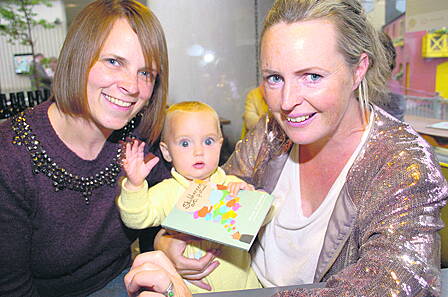 Eight-months-old Beau Montgomery-Callaghan admires the programme for the 2015 Skibbereen Arts Festival with her mum, Susan Montgomery from Clonakilty, and Sarah Ruttle, Ballydehob, at the festival launch at Kalbos Uillinn on Tuesday evening. The Southern