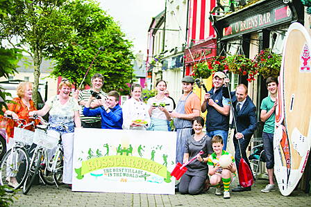 Business people and residents of Rosscarbery at the unveiling of the villages confident new logo (inset) and tagline. 