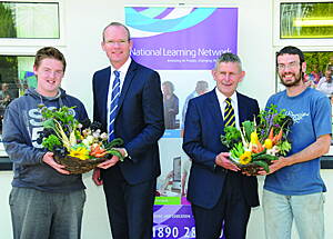 Making a presentation of produce grown in the polytunnels at NLN Bantry, to guest speakers Minister Simon Coveney and CEO of CETB Ted Owens, following the presentation of certifiates to graduates of the centres first Food Production course. 