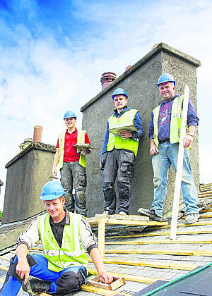 John Murray, centre standing, with his work colleagues, Artur Kuramsin, Jeremiah Hourihan and John ODonovan