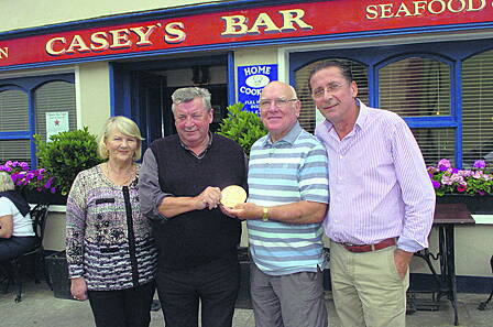 Frank Fahy holding his gran-uncle Patrick Collins memorial plaque, with Michael and Martha Casey and Paul Heaphy of Caseys Bar in Union Hall.      