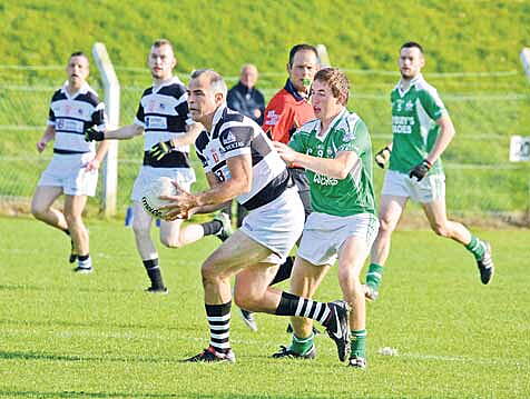David Brosnan of St Nicks being tackled by Eoin Lavers of Dohenys in the drawn game last Saturday evening. 