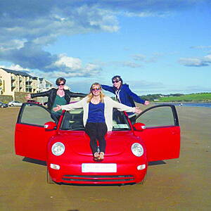 Bebeanne, left, with Corinne and Gina, and Hairy Coo the red VW Beetle on yet another beach! Below: at various stops on their epic trip around Irelands top attractions