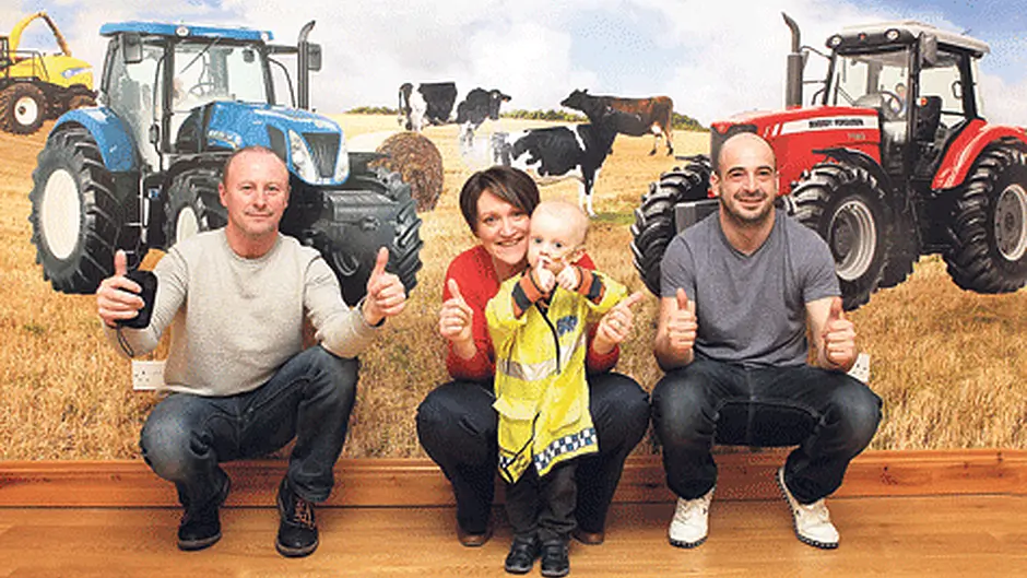 Rory and Sam in the driving seat of charitys surprise tractor mural Image