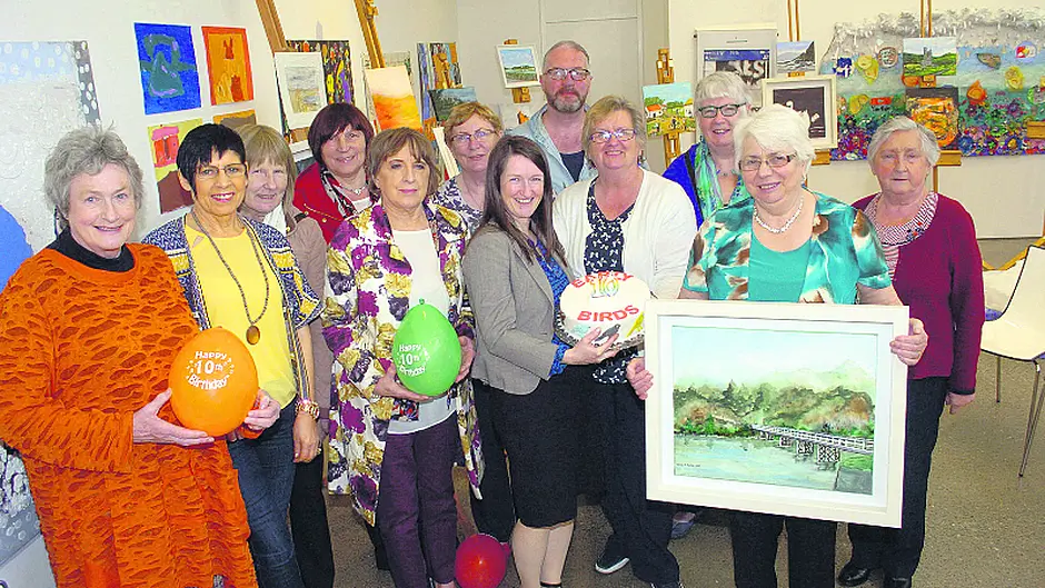 Group celebrating ten years of fun, friendship and art appreciation Image