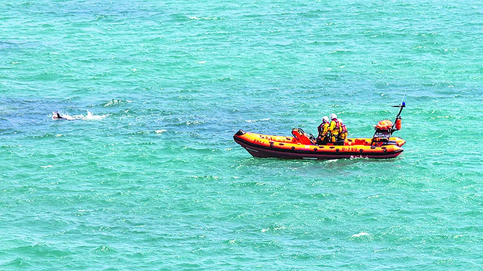 RNLI escorts swimmer back to shore Image