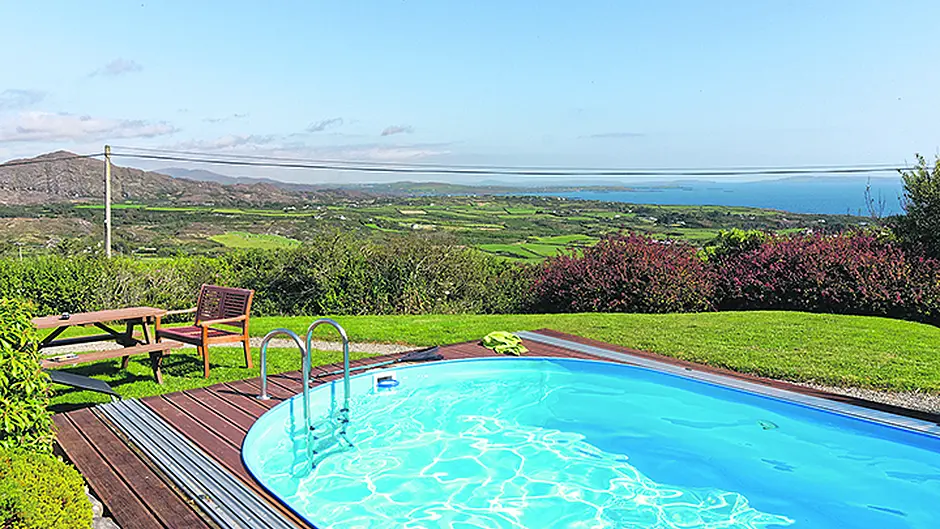 Soak up views in outdoor heated swimming pool Image