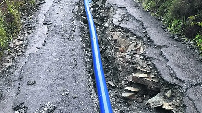 Downpour rips up repaired road Image