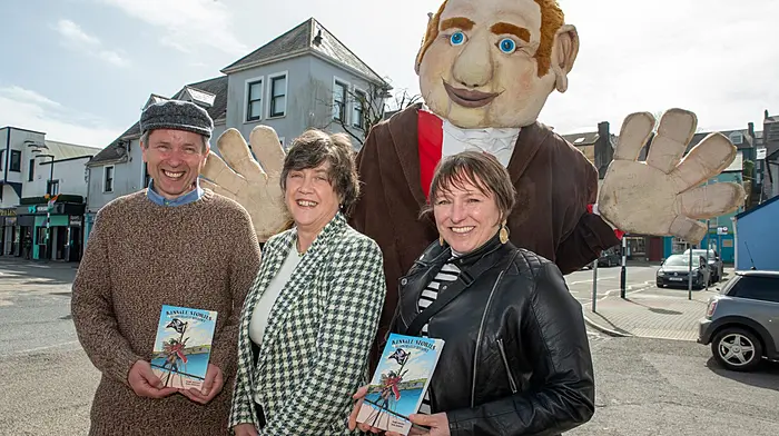 Author Barry Moloney with Angela Shanahan from Kinsale Tourist Office and illustrator Fiona Boniwell with the Kinsale Giant at the launch of Kinsale Stories an illustrated children’s history of Kinsale.   (Photo: John Allen)