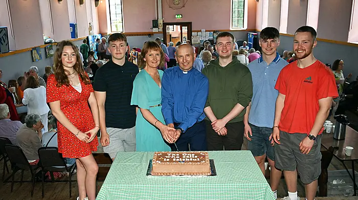 Reverend Kingsley Sutton and his wife Daphne cutting the cake to mark Rev. Kingsley’s 25th anniversary of his ordination to the priesthood.  Included are their children (left to right): Rosanna, Jonah, Matthew, Ralph and Harry.  Following service in Kilgarriffe Church, the reception took place in the parish hall. (Photo: Martin Walsh.)