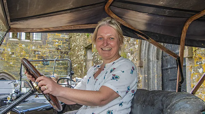 Triona O’Sullivan of Kilbrittain Historical Society, at the wheel of a 1925 Model T,  gave a detailed account of the history of Kilbrittain Castle to a visiting group of Ford Model T enthusiasts on the castle grounds.    (Photo: Gearoid Holland)
