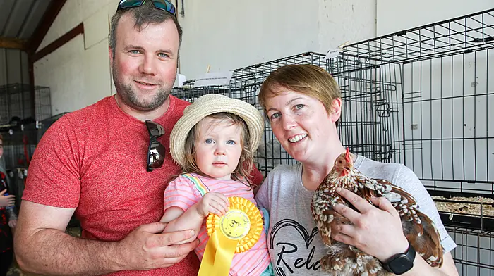 Katie Stafford (2) with her parents Pa and Erica from Rosscarbery after winning third prize in the junior section with her Pekin hen called Dora at the recently held Bandon Agricultural Show. (Photo: David Creedon)