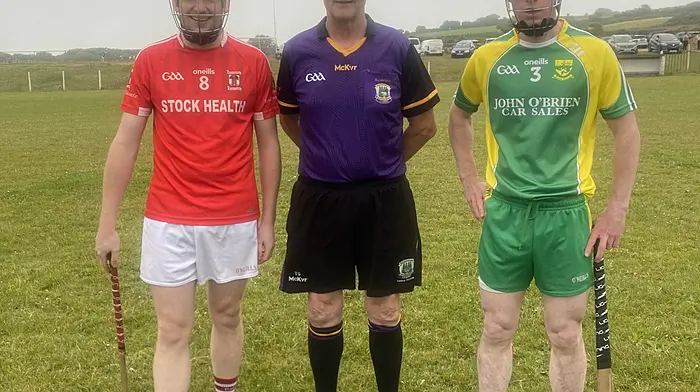 Ballinascarthy captain David Walsh with referee T Sheehan and St James' captain Eoin Deasy.