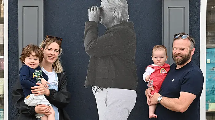 The Twomey family in Kent Street, Clonakilty beside the image of Colette Twomey, one of the ‘disappearing’ images, the work of German artists David and Maria Vill Mannstein from Waldaschaff in Germany, the town that is twinned with Clonakilty.  From left: Oliver, Lorna, Beth and Ed.  (Photo: Martin Walsh)