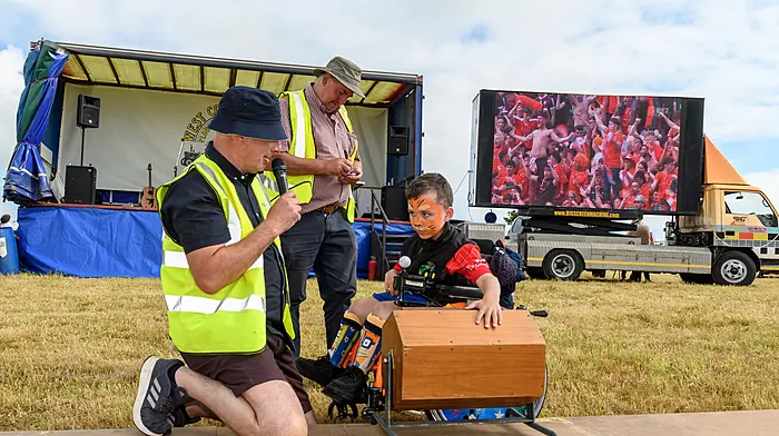 Sean O'Flynn, Paddy Ryan and Adam Clarke (Newcestown) who drew the winning ticket from the drum in the raffle, first prize was a CFMOTO 450 Quad Bike as Armagh fans celebrate winning the All Ireland Football title in the background on a big screen. The West Cork Vintage Ploughing & Threshing Association annual Charity Vintage Working Day was held in Killavarrig, Timoleague. Proceeds from the event will go to the New Autism Unit at Clogagh National school, Bantry Stroke Unit and The West Cork Jesters.Picture: David Patterson, Tractor Run – Cork