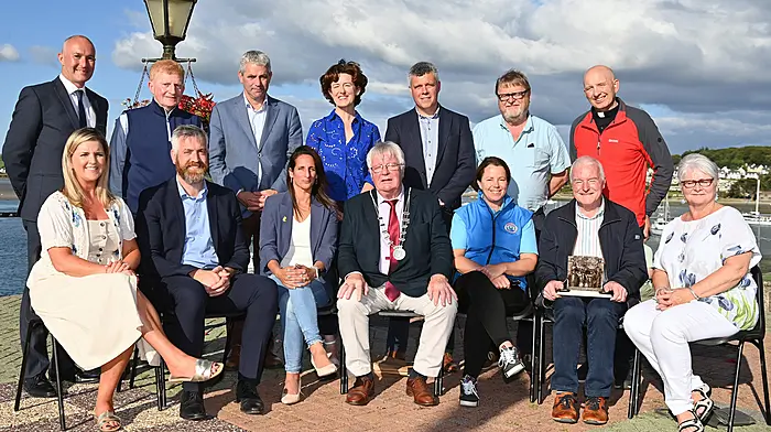 At the official opening of the Courtmacsherry Harbour Festival last Saturday evening were (seated, from left) Cllr Ann Bambury, Christopher O’Sullivan TD, Anat O’Donovan, county mayor Cllr Joe Carroll, Ellen Adams, Gerald O’Donovan (recipient of the recognition award) and Deirdre Barron.  Standing (from left) Paul Hayes, Vincent O’Donovan, Senator Tim Lombard, Cllr Gillian Coughlan, Cllr John Michael Foley, Cllr John Collins and Rev Kingsley Sutton.  (Photo: Martin Walsh)