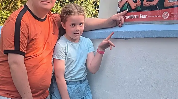 The Southern Star’s poster for the Olympics outside Noreen Desmond’s house being admired by Ronan Desmond from Templemartin and his niece Mary Kate Cassidy.