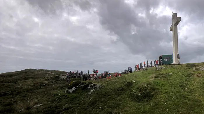 Paul Moore of Bere Island Community Radio took this photo of the annual mass at the Holy Year Cross, Cnoc an Eallaigh, on Bere Island which was celebrated by Fr Lawrence Freeman OSB and attended by the island community as well as visitors from home and abroad.  The Bere Island diaspora also joined the community celebration via a livestream from Bere Island Community Radio.  The mass is organised annually by the Holy Cross committee to occur on August bank holiday Saturday.