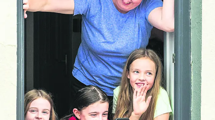 these supporters took up a great,
eye-level, vantage point with the Olympians as they
passed through Skibbereen in an open-top bus (Photo: Andy Gibson)