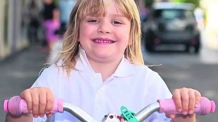 Local girl Minnie Pelter out and about on her scooter on
Pearse Street, Clonakilty. (Photo: Martin Walsh)