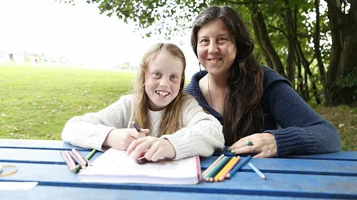 Jennifer Shore and her daughter Ella Shore Luftos (8) from Ballydehob enjoying colouring her book at the park on a visit to Schull. (Photo: Carlos Benlayo)