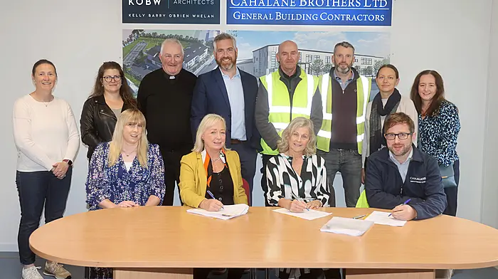 At the signing of the contracts for the construction of the new primary school in Ballinspittle are (seated, from left): Louise Lyne (deputy principal), Sarah Kelly (chief architect), Shiela Wall (principal, Ballinspittle NS) and Cian Cahalane (contractor).  Back (from left): Anne Galvin (board of management and treasurer, parents association), Anett Bognar-Nemeth (AtkinsRealis), Fr Michal O'Mahony PP, Christopher O'Sullivan TD,  Liam Daly (clerk of works),  Damien Whyte  and architects Aurelija Jusaite-Ulutas and Elaine Dinan.