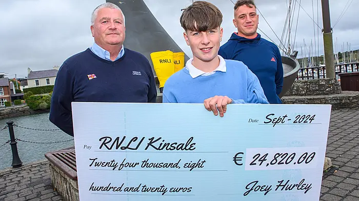Kinsale teenager Joey Hurley raised €24,800 for the RNLI in memory of his beloved uncle, the popular local fisherman, Des Hurley. Joey, who undertook the gruelling ‘Duathlon for Des’  is pictured here presenting the cheque to John O’Mahony of Kinsale RNLI. Also included is Joey’s personal trainer Mikey Power.                               (Photo: John Allen)