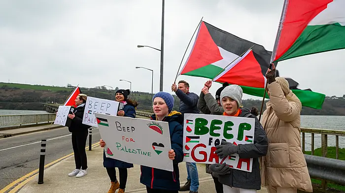 Members of the Kinsale for Palestine group out on the Archdeacon Duggan bridge encouraging motorists to show their support by sounding their horns back in March. (Photos: John Allen)