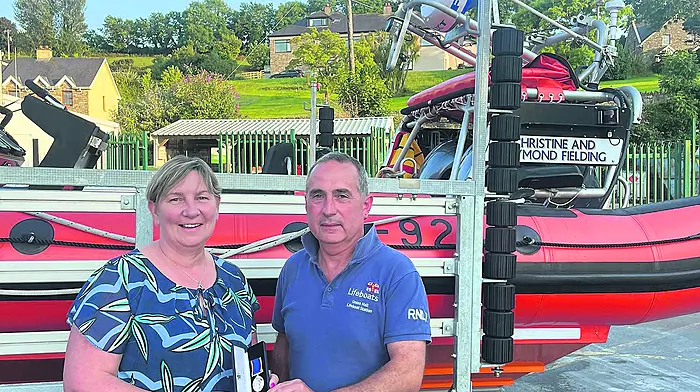 Mary Rose Deasy, Union Hall, receiving an award in recognition of her 20+ years of fundraising work in support of the RNLI from local lifeboat operations officer John Kelleher in August.