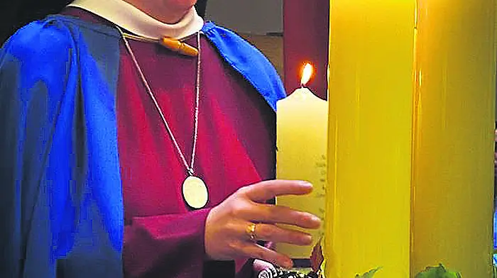 Sr Máire Bríd O’Driscoll from Enniskeane  lighting a candle at her recent solemn profession into the ‘Red Nuns’ (Sisters of the Holy Redeemer).