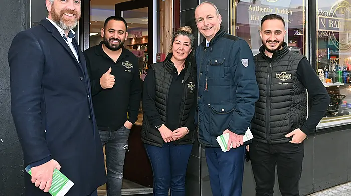 Staff of the Golden Scissors barbers in Bandon with Micheál Martin, Tánaiste, Minister for Foreign Affairs and Defence and Christopher O’Sullivan, TD in Bandon in October. (Photo: Martin Walsh)