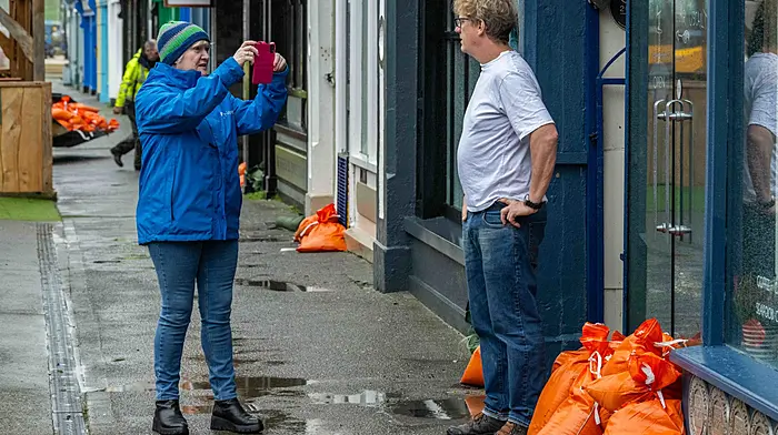 RTÉ reporter Cathy Halloran interviewing Diarmaid Murphy of Bantry Business Association after Storm Bert brought torrential rain to Bantry under a Met Éireann red weather warning, but the town didn't flood. People were out early going to work whilst Cork County Council workmen took sandbags back to the council depot.   (Photo: Andy Gibson)