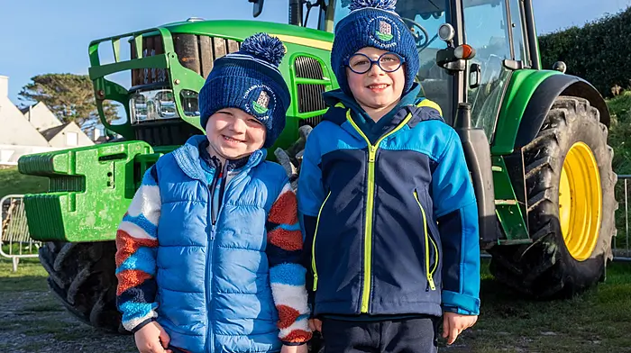The annual old time threshing event in Tragumna, West Cork took place today at the Skibbereen Eagle pub car park. Hundreds of people attended the event which was held in aid of local charities. Checking out a John Deere tractor were Daniel & James O'Sullivan from Tragumna. Picture: Andy Gibson.