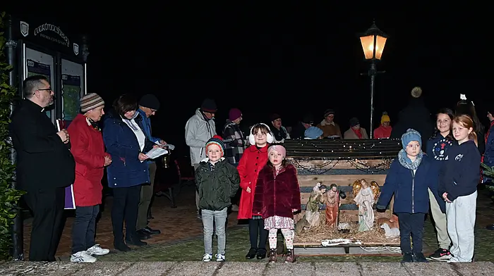 Local children at the inauguration of the Community Crib with Fr Fergus Ryan at the promenade in Courtmacsherry. Santa and Mrs Claus turned on the Christmas tree lights and the local choir provided the music and song. (Photo: Martin Walsh)