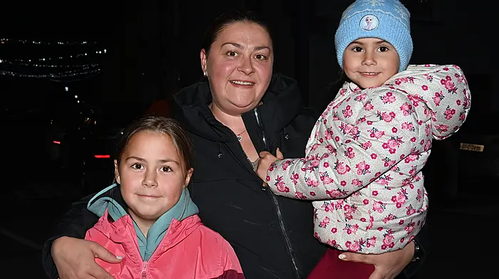 At the switching on of the Christmas lights, carol singing and Santa’s arrival in Timoleague on Sunday evening last were locals Emily, Mirela and Amy Harrington. Photo: Martin Walsh.