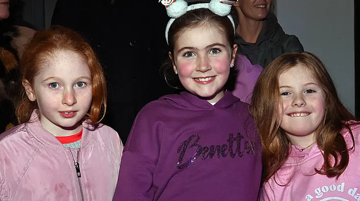 Local girls Amy Griffin, Rosie Harte and Phoebe Barry at the switching on of the Christmas lights, carol singing and Santa’s arrival in Timoleague on Sunday evening last.  Photo: Martin Walsh.