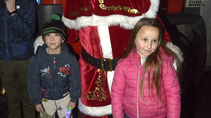 Waiting for Santa to switch on the lights recently in Bandon were Liam Tobance and Hanna Molnarr. Photo: Denis Boyle