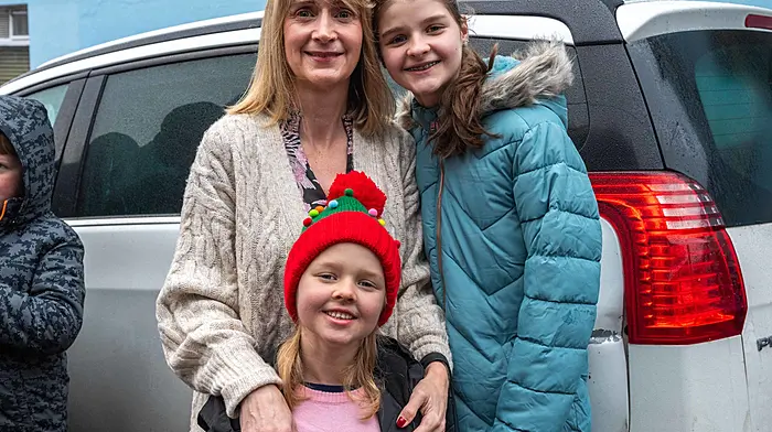 Edel, Kaitlin, and Saoirse Murphy wait to meet Santa Claus in Bantry. The event was organised by Bantry Business Association. (Photo: Andy Gibson)