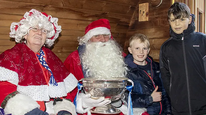 Sean Burke and Eoghan Timmins meet Santa and Mrs Claus and get up close with the Andy Scannell Cup which Castlehaven claimed for winning the Cork senior football championship. (Photo: Andrew Harris)