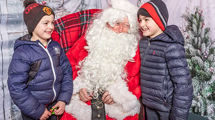 Zach and Dean O’Sullivan having a chat with Santa in his grotto in Castletownbere. (Photo: Anne Marie Cronin)