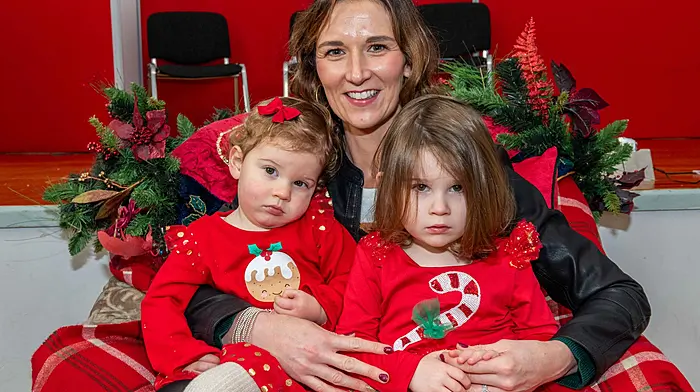 Anna, Eve (1) and Mila (2) Deasy from Clogagh waiting to meet Santa at Ballinascarthy Community Hall. (Photo: Andy Gibson)
