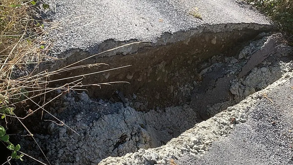 Broken bridge means locals are taking the long road home Image