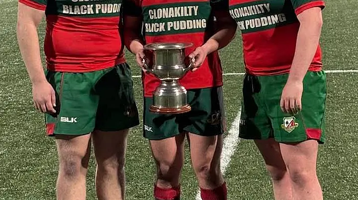 Timoleague locals (from left): Luke McCarthy, Christopher Walton, and Marcus Kelly with the spoils of victory after defeating Sunday’s Well with the Clonakilty Rugby Club in the final of the Dineen Cup which was played at Virgin Media Park in Cork last Wednesday.