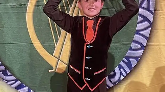 Fionán Crowley, son of John and Denise Crowley from Lyre,  lifting the World Championship trophy he and the U13 mixed céilí team from the Kiely Walsh Academy won at the CLRG Irish Dancing World Championships at the Convention Centre in Dublin last week.
