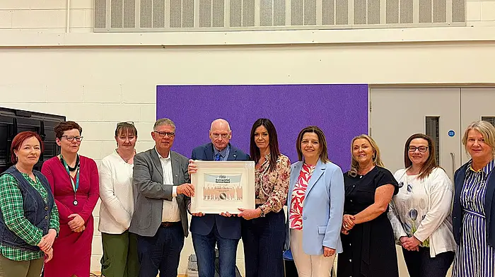 School Secretary Cionnaith O’Suilleabhain (centre) was recently awarded a the Fòrsa award for distinguished service.